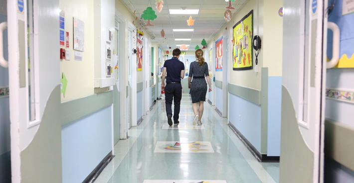 Two doctors walking down hospital corridor