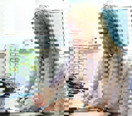 Female GP At Desk Taking Notes DGP181016