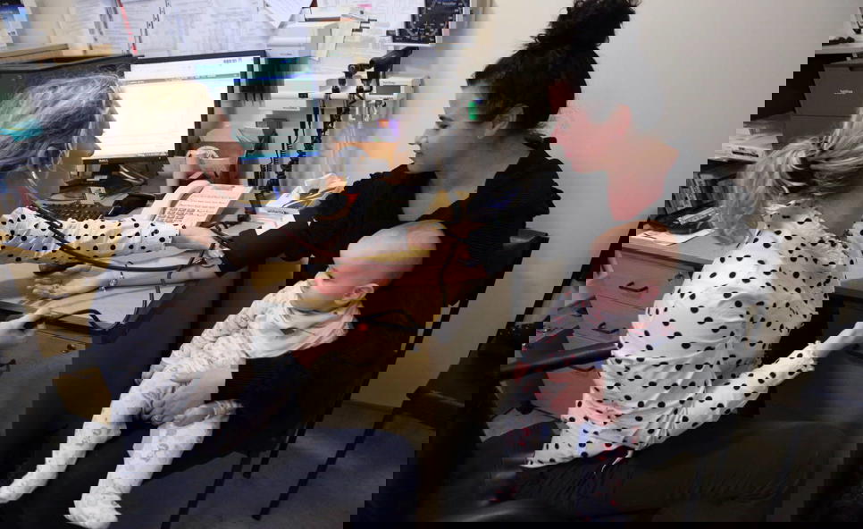 Female GP With Patient